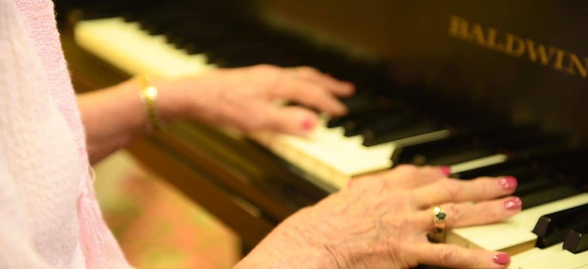 Elderly woman playing the piano