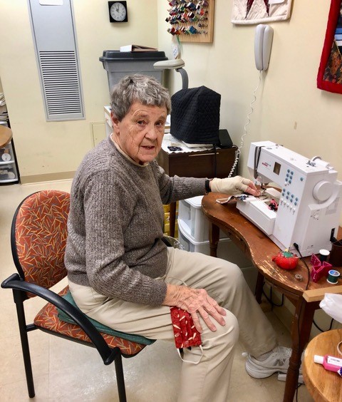 elderly woman sewing face masks