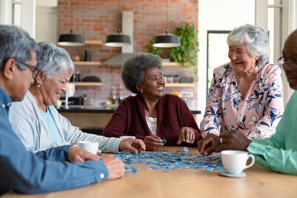 A group of seniors do a puzzle together