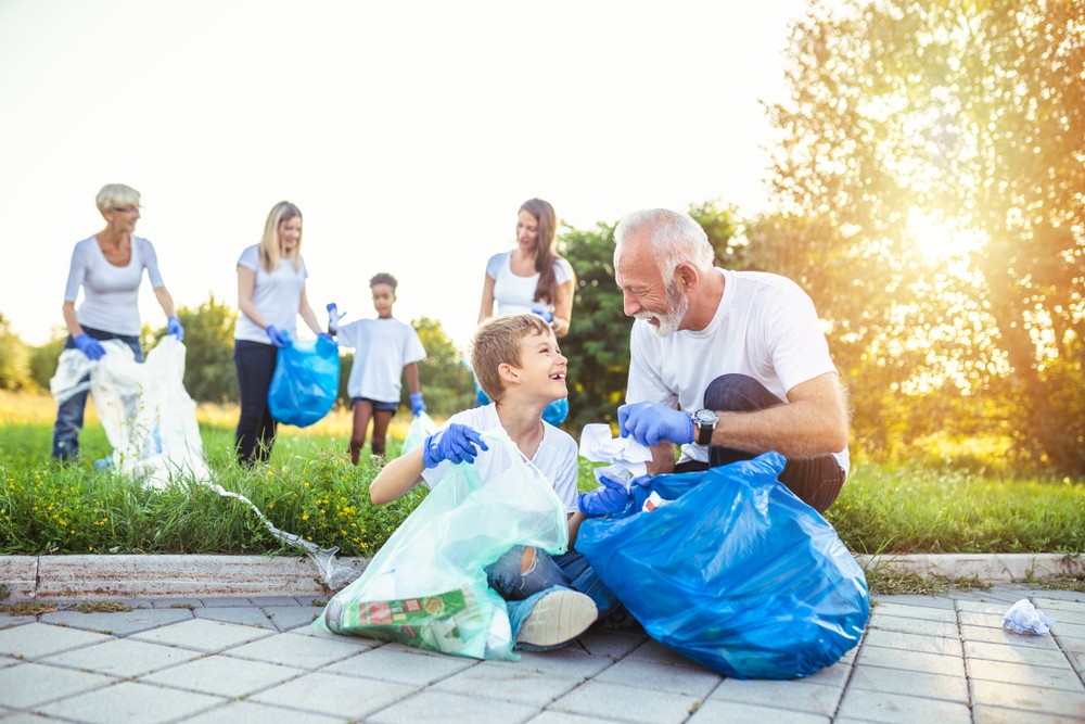 Group of multigenerational volunteers picking up trash