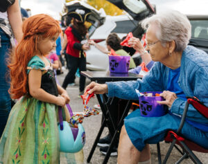 Senior giving out candy during halloween