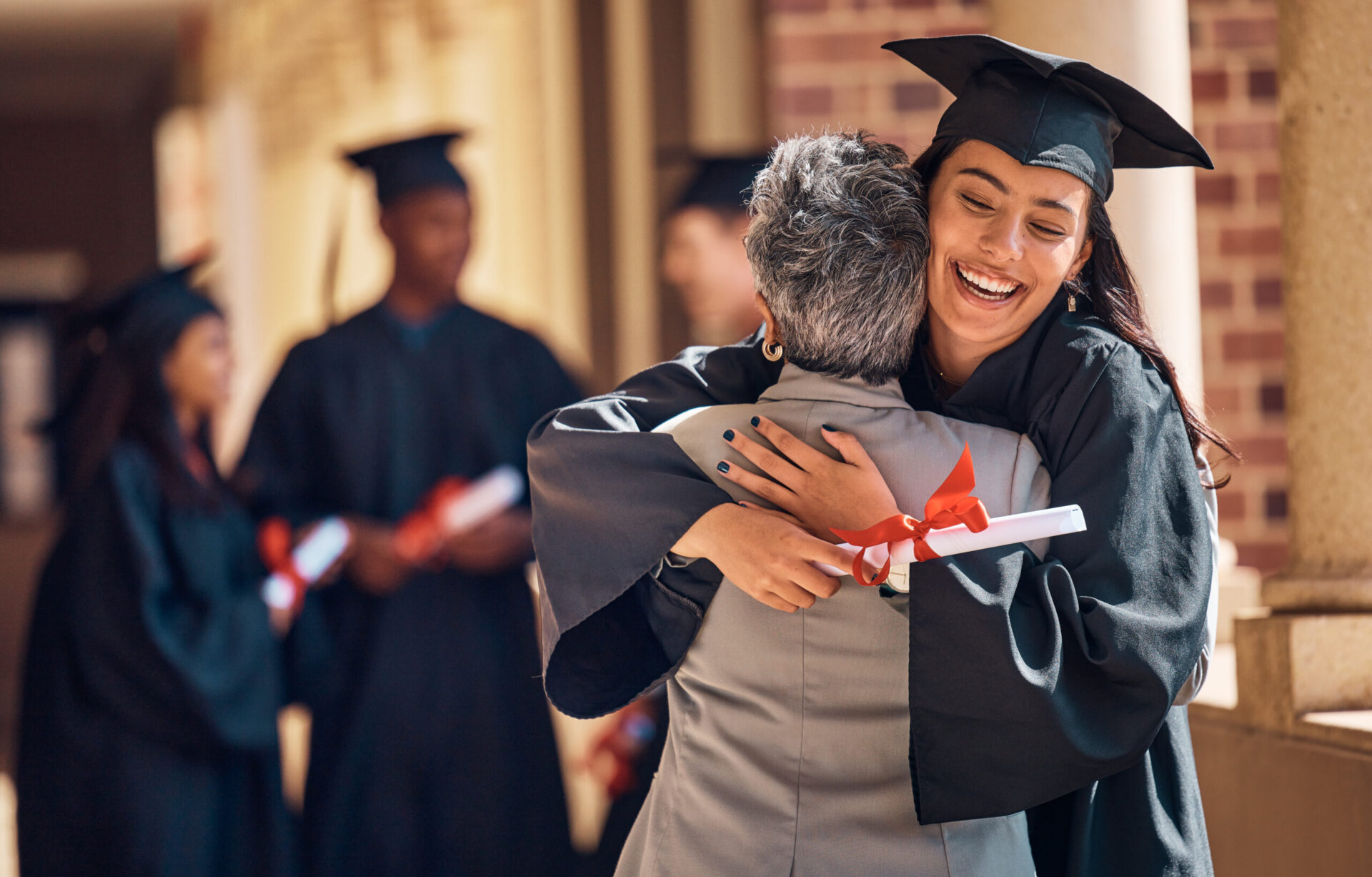 Youge graduate hugs mother