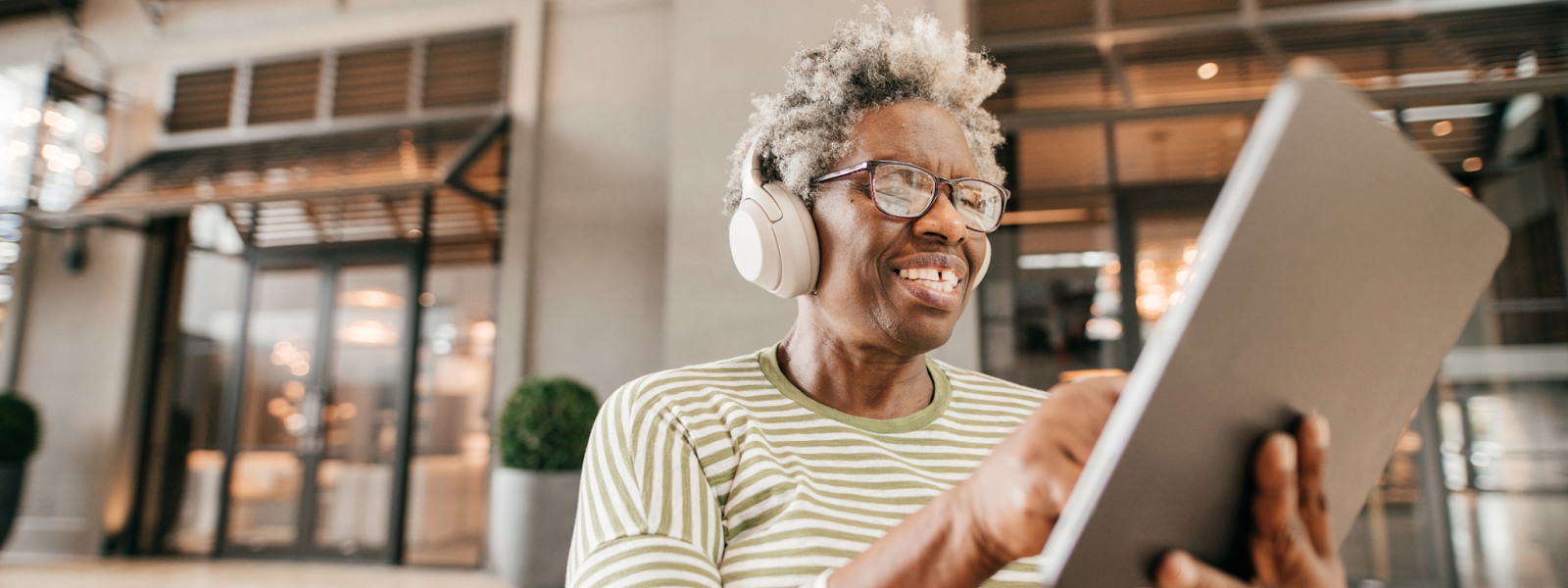 Senior woman using technology and wearing headphones