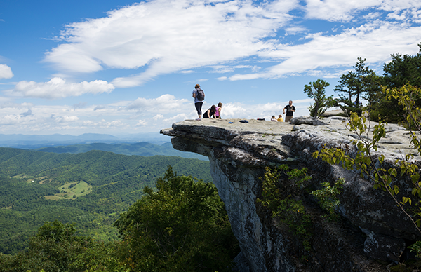People standing on a cliff near The Glebe