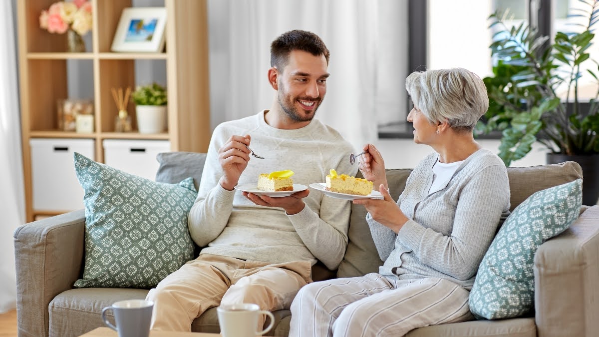 Young man and senior woman enjoying pie