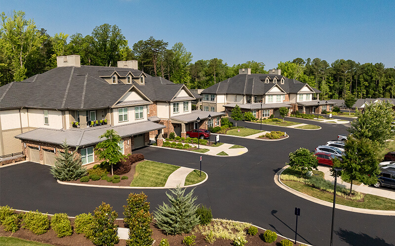 Aerial View of Senior Community Aerial view of a senior living community with landscaped gardens and paved paths.