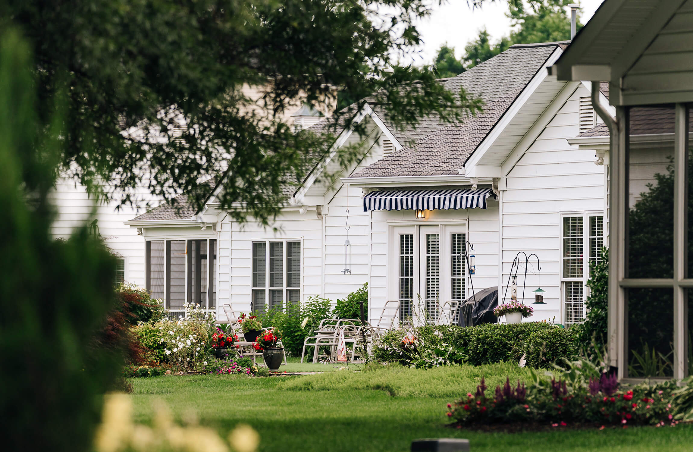 Charming Units in Tranquil Setting Charming white units with gardens in a tranquil setting surrounded by greenery.