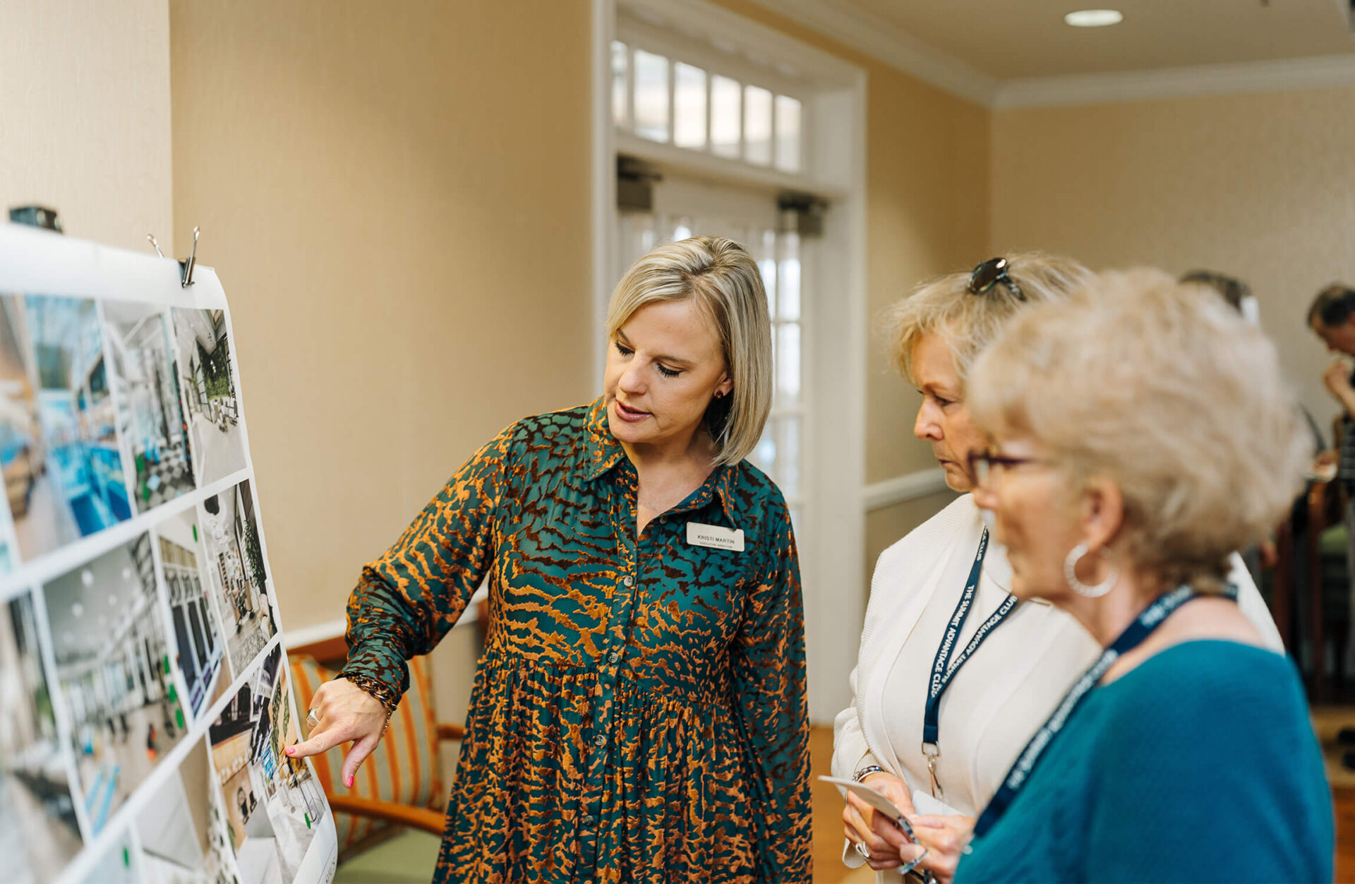 Seniors discussing expansion and reviewing renderings of buildings