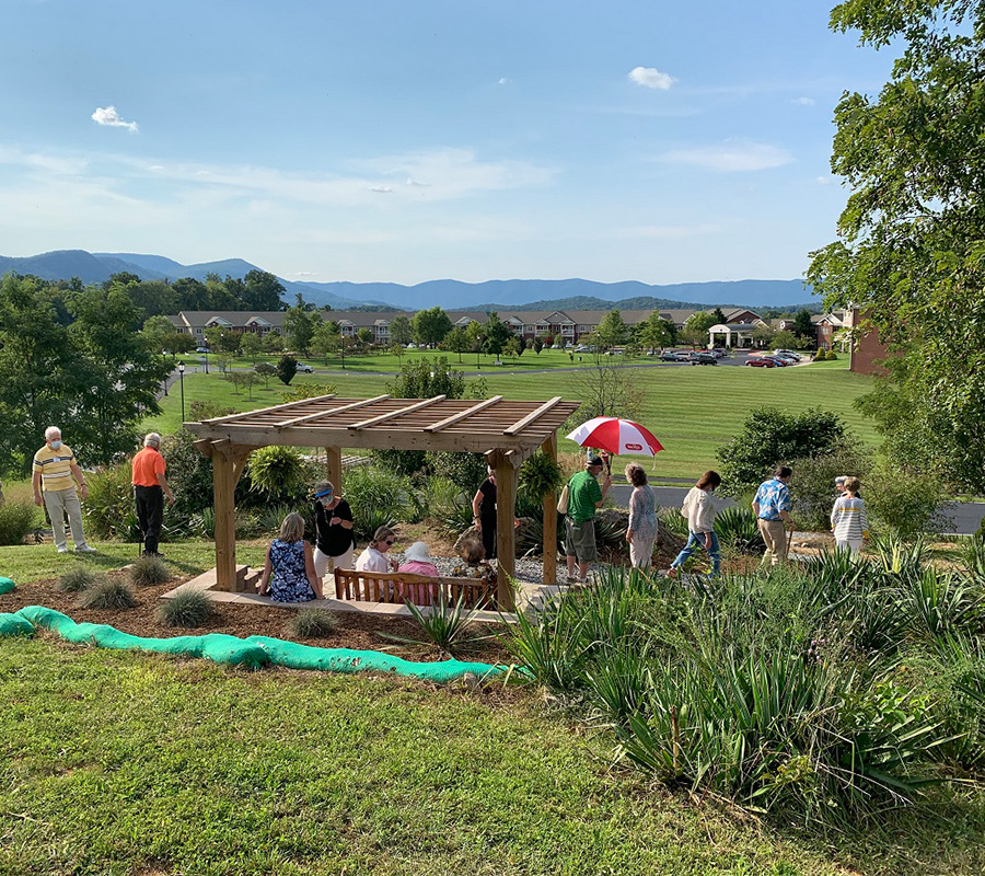 Community gathering in a garden at The Glebe