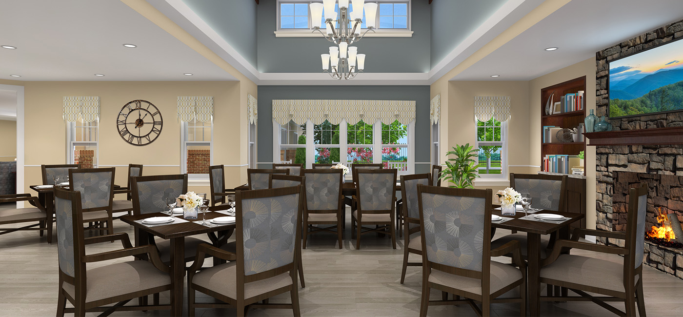 Elegant dining area with a fireplace, tables set for a meal, and a large window view.