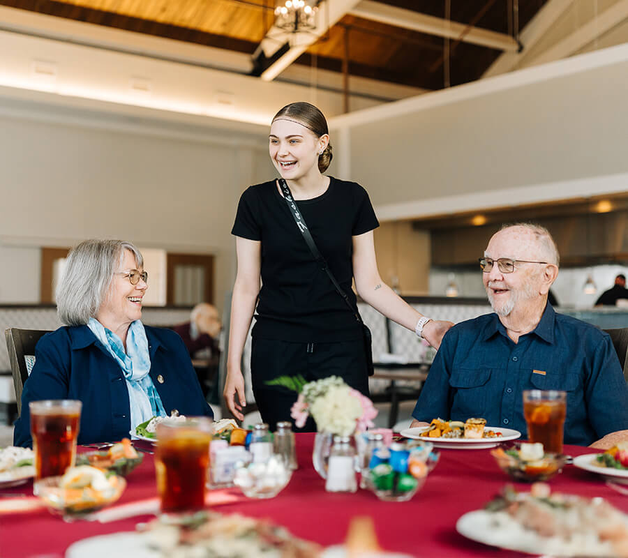 Senior's laugh at dinner with staff