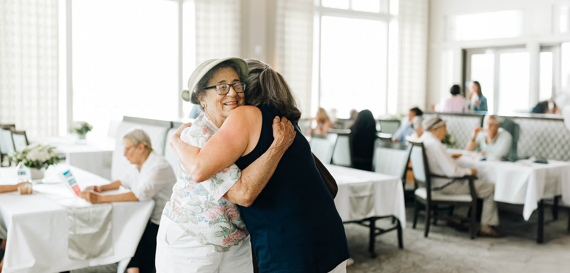 Residents share a hug in a Culpeper dining room