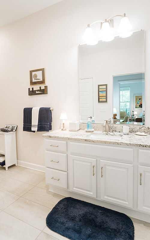 Elegant Bathroom in Residential Unit Bright bathroom with marble countertop and large mirror in residential unit.