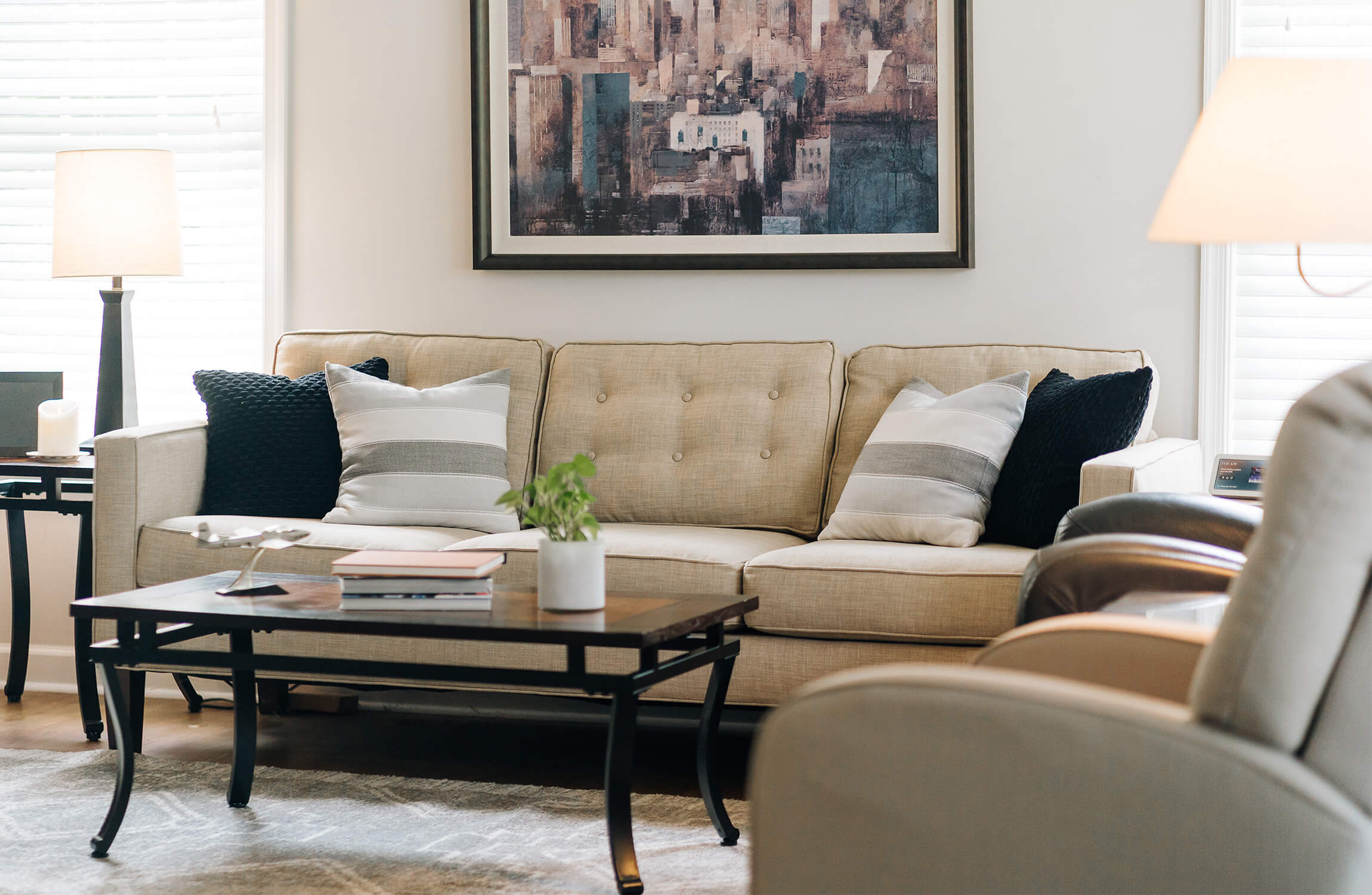 Elegant Living Space Interior Comfortable living area with beige sofa, abstract artwork, and modern decor.