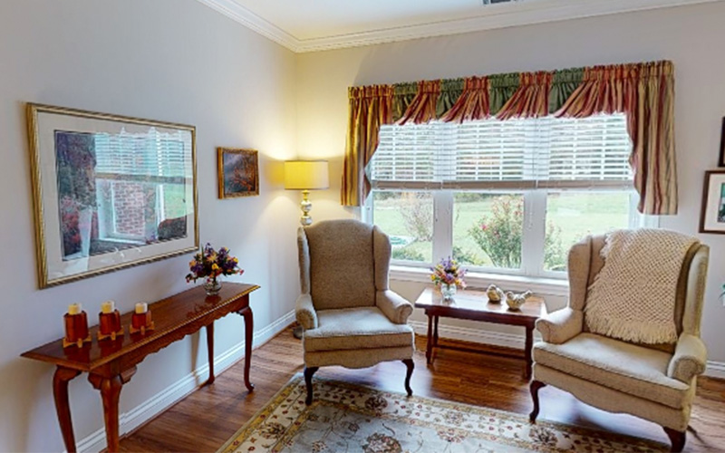 The Glebe living space with elegant chairs and decor