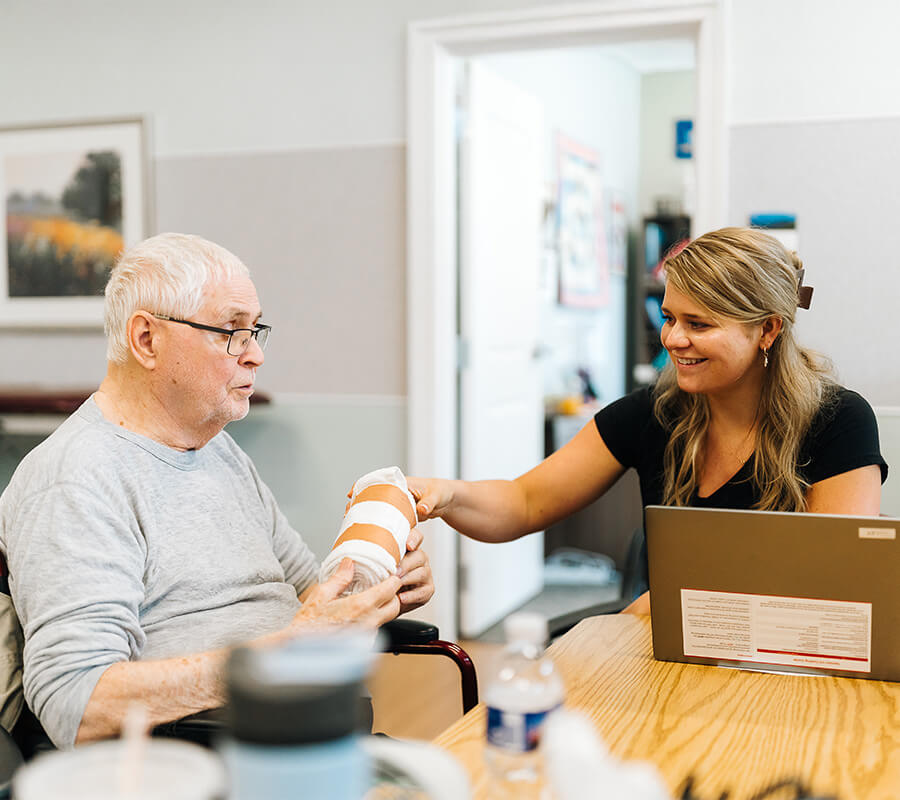 Woman and senior talk about physical therapy