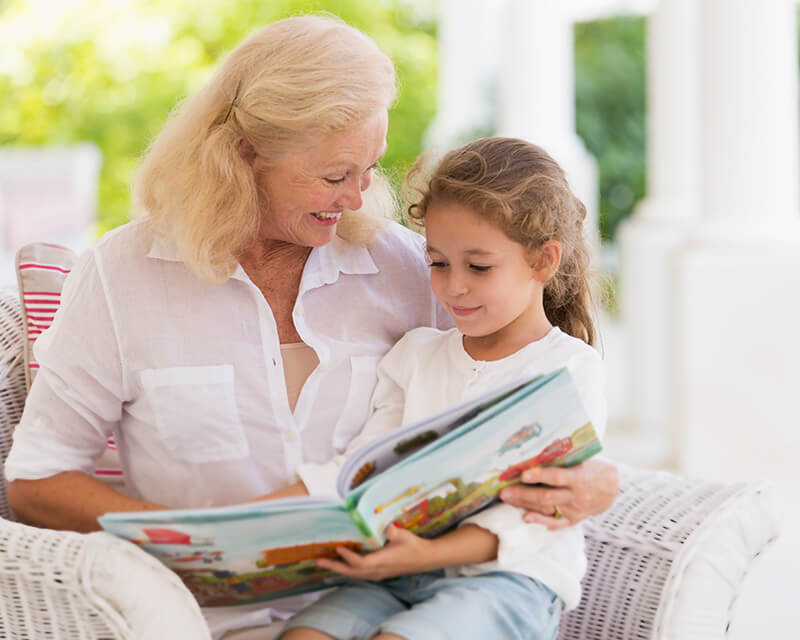 Grandma reading a book to her grandchild