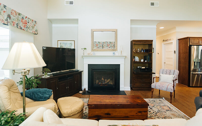 Inviting Living Room in Senior Community Unit Cozy living room in a senior community unit with fireplace and comfortable seating.