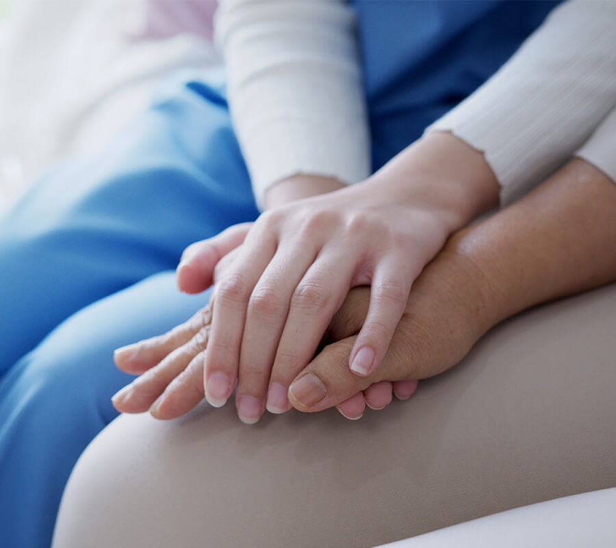 Senior and adult holding hands