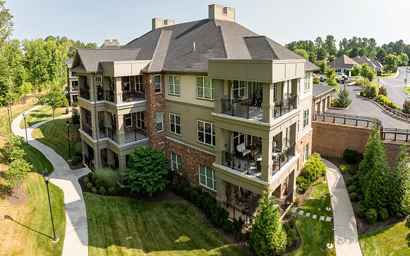 Scenic Residential Building with Balconies Aerial view of a residential building with balconies in a landscaped senior living community.