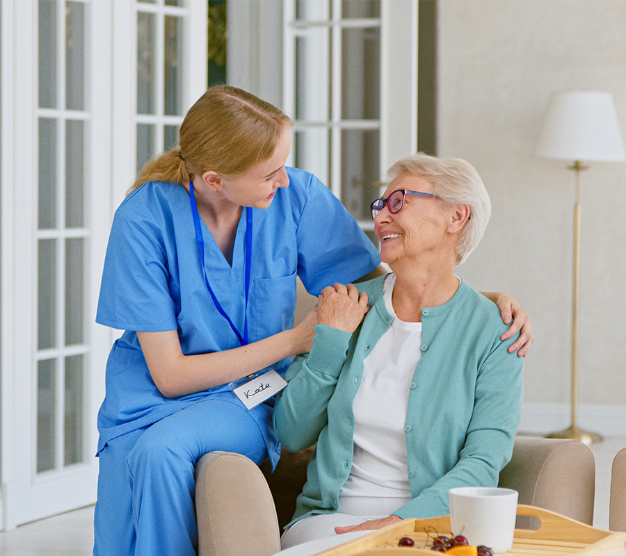 Senior woman relaxing on couch with caregiver