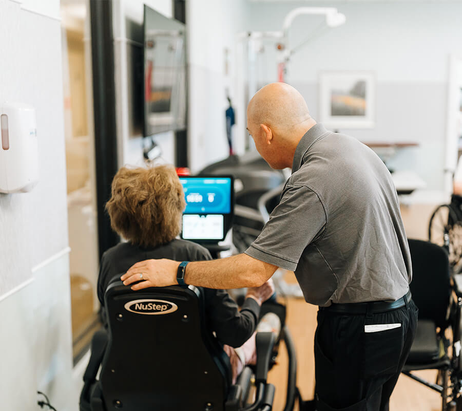 Senior woman and physical therapist in gym