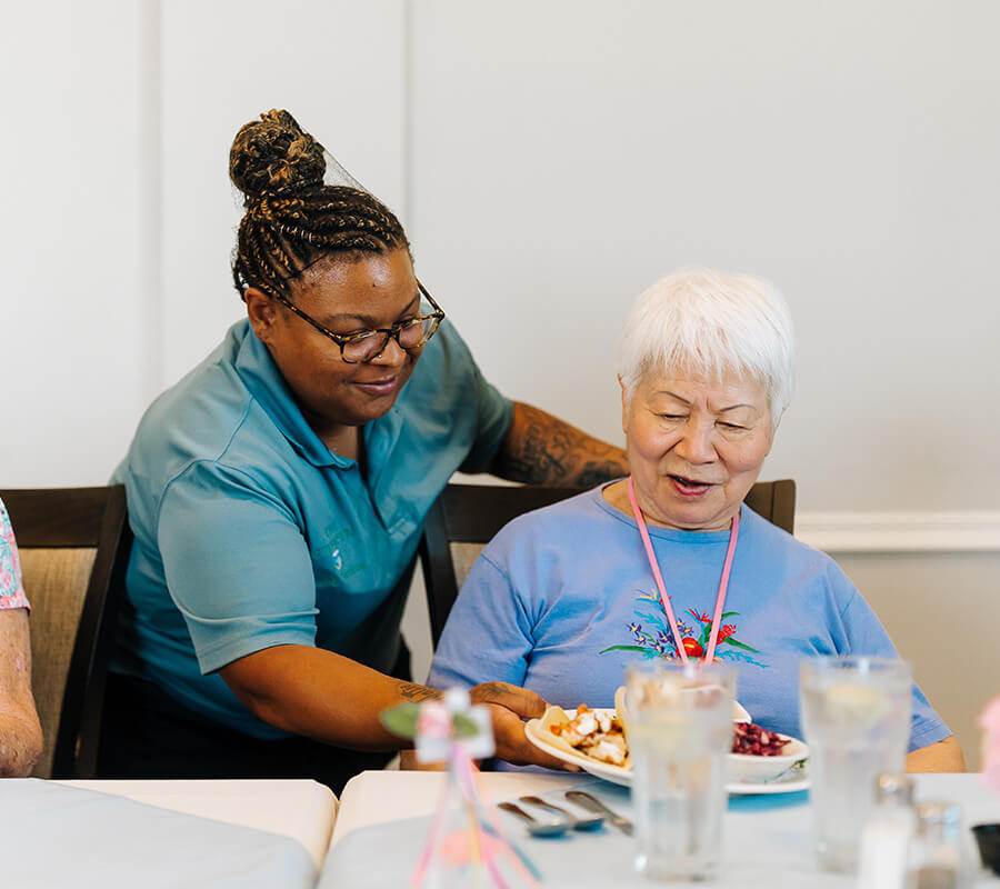 Senior woman being served dinner