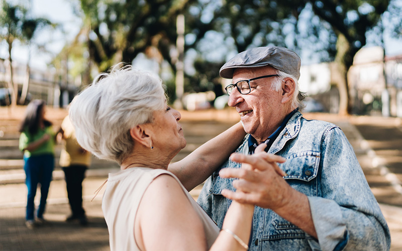 Senior couple dance in a park