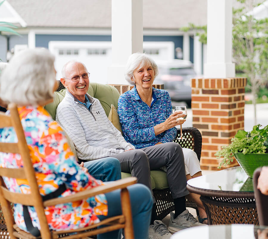 Senior friends laugh outdoors