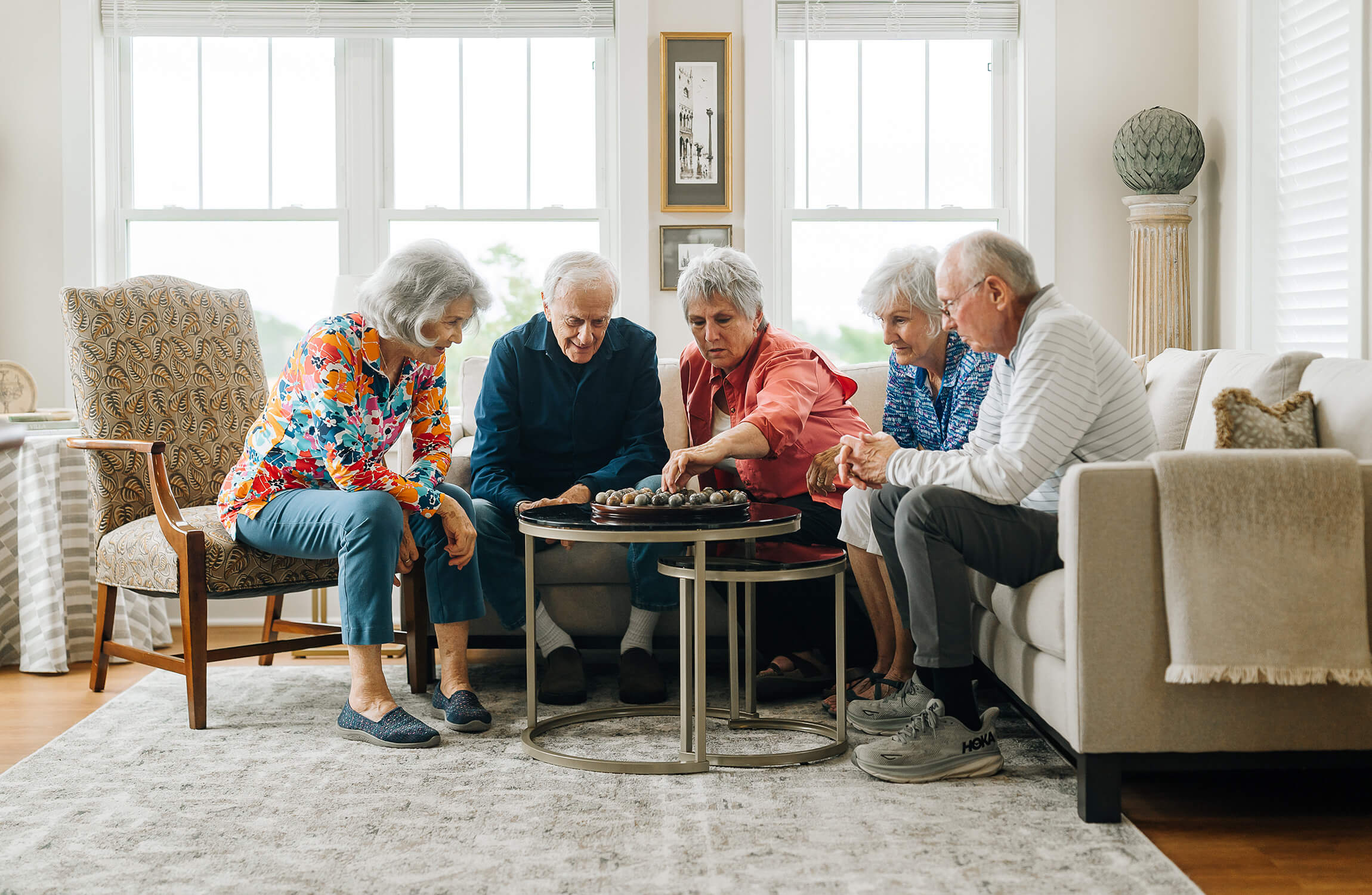 senior-friends-playing-board-games Senior friends playing board games in home living room