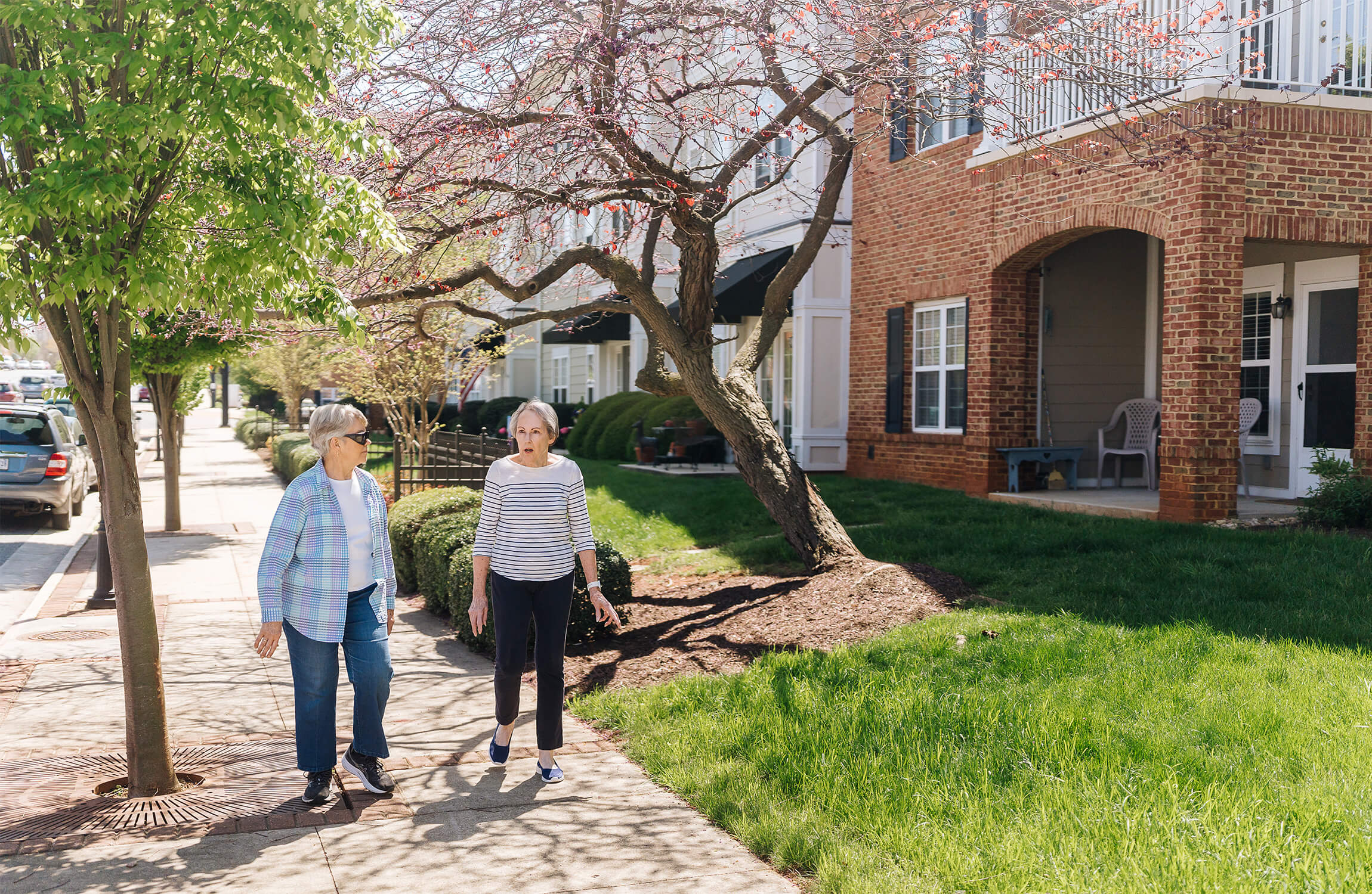 senior-friends-walking-through-neighborhood senior friends on a stroll through summit neighborhood