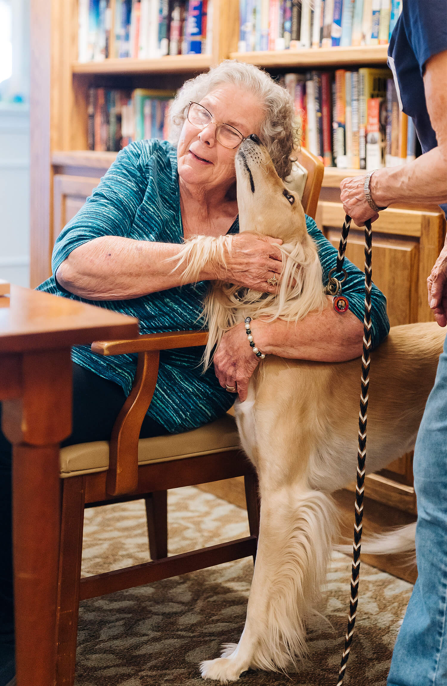 Senior woman hugging dog