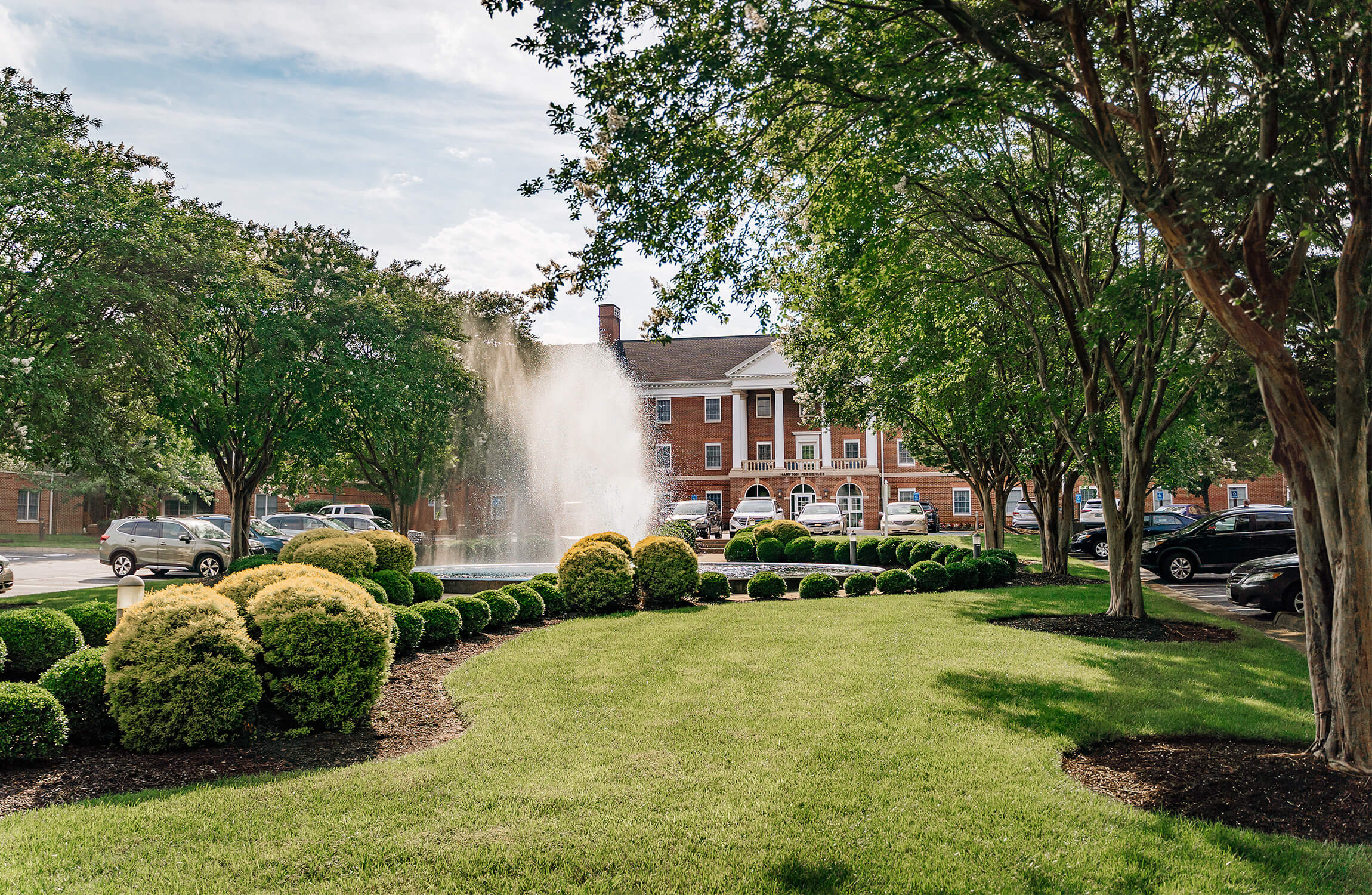 Community entrance view of large fountain and landscaping