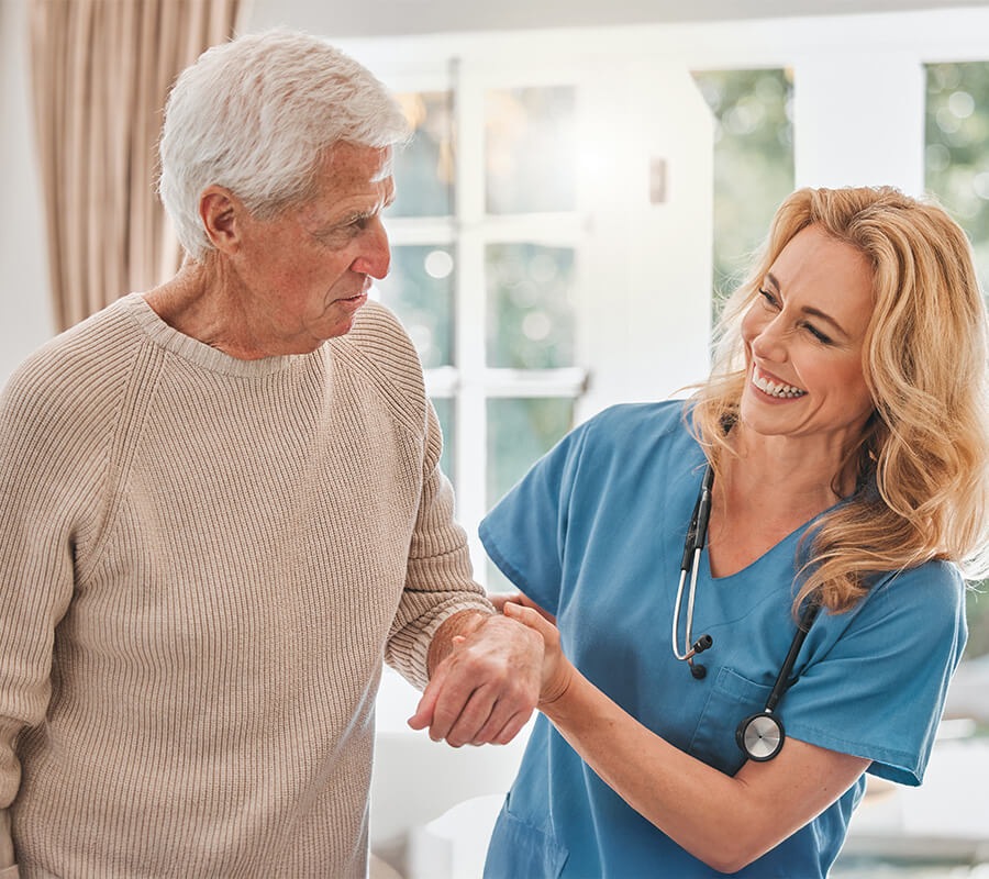 Senior man getting assistance from nurse