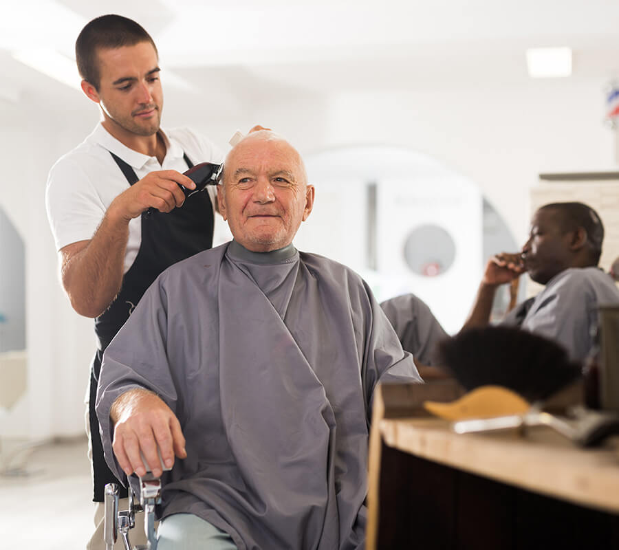 Senior man receiving a haircut