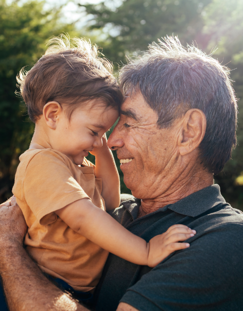 senior man talking to his young grandchild