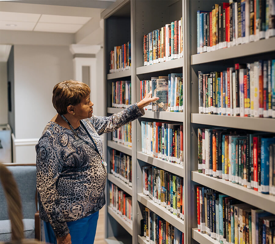 Resident viewing book at a library