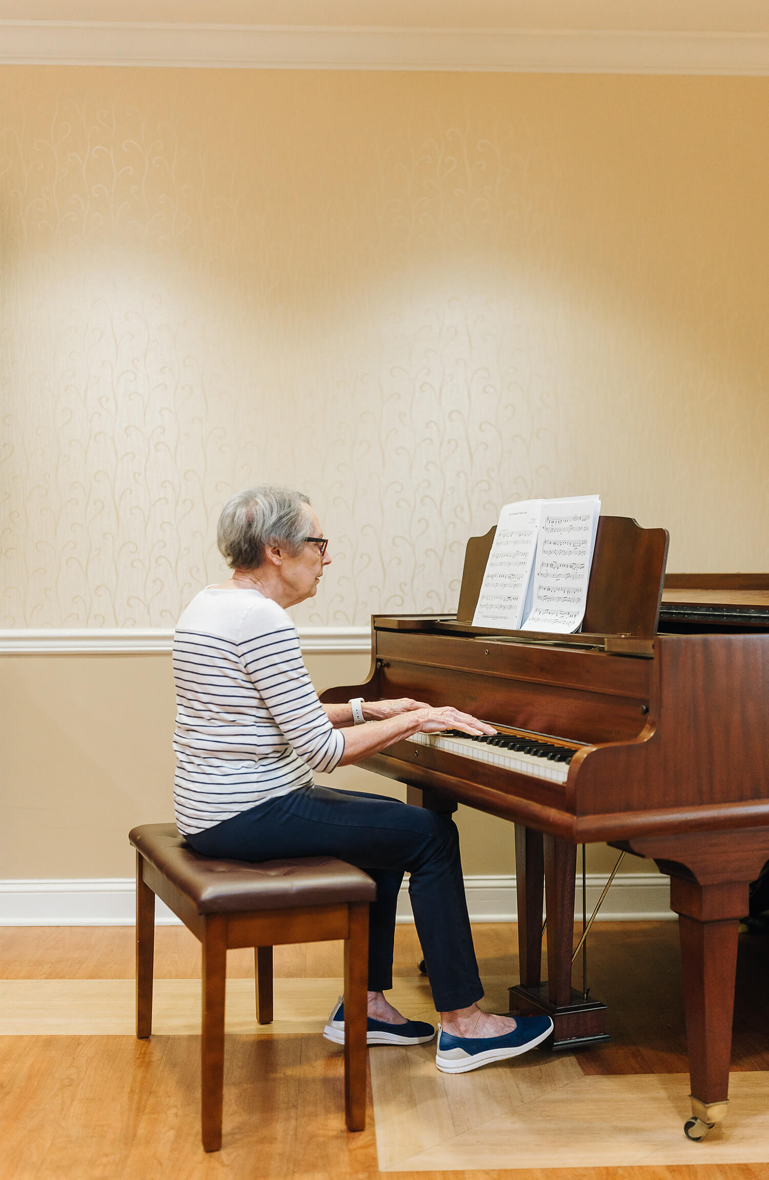 Senior woman playing piano at The Summit