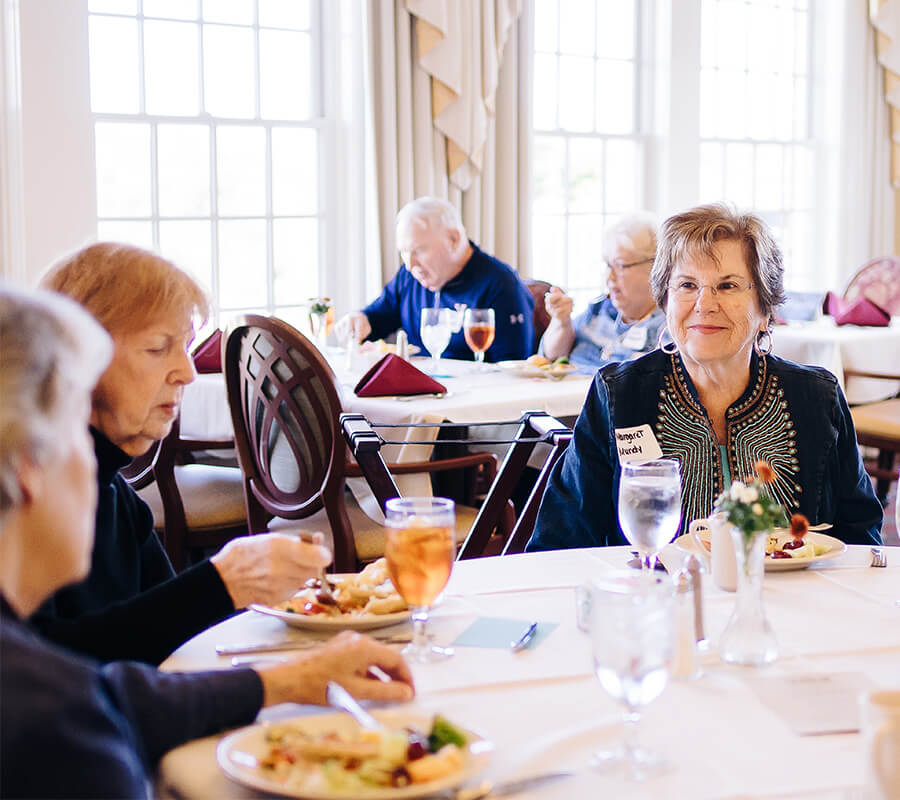 Senior women sitting together enjoying dinner