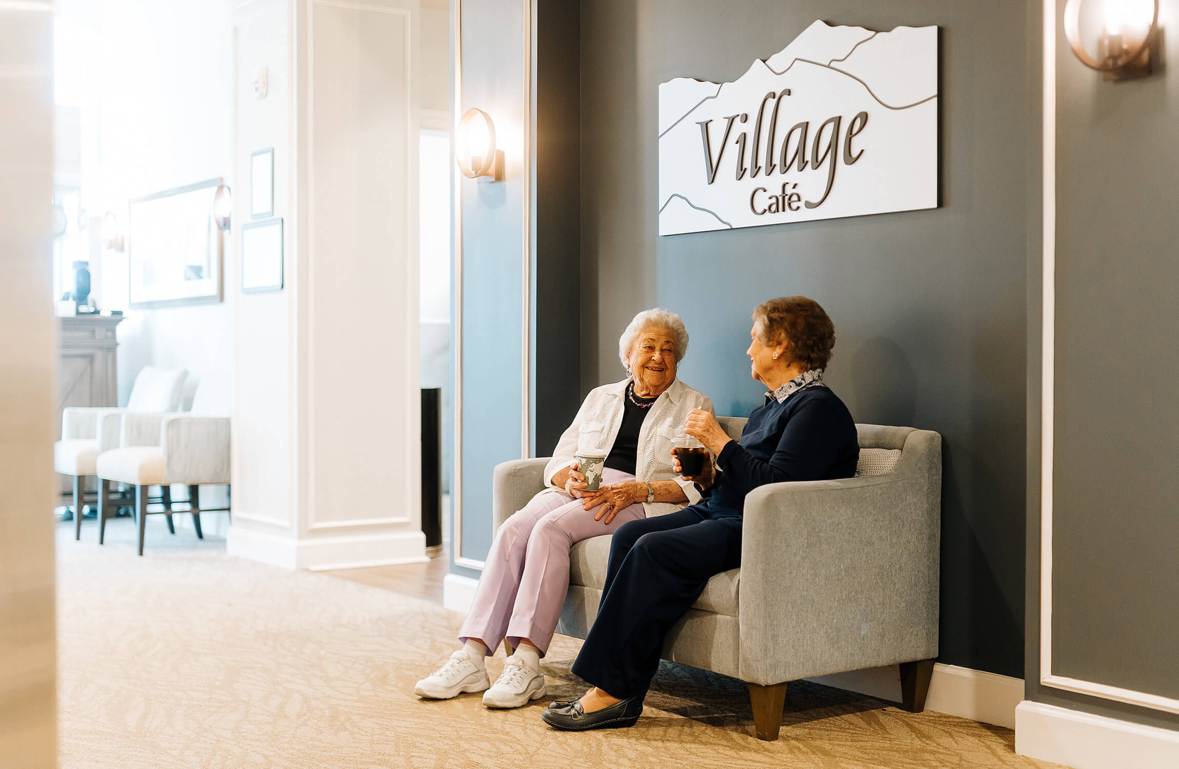 Two senior women sitting in the village cafe