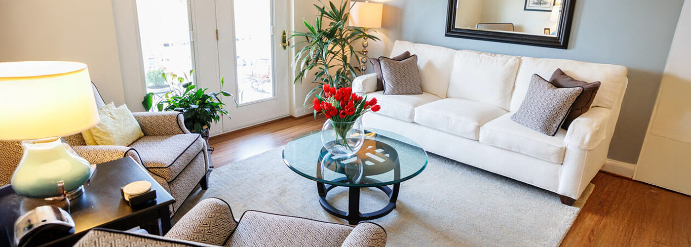 Cozy living room at The Glebe with bright red roses on coffee table