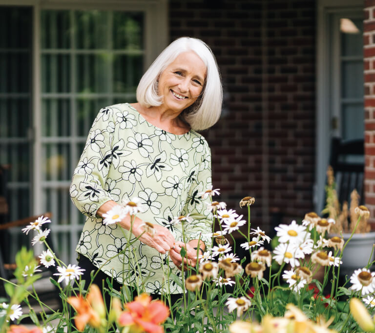 senior woman looking at her flowers