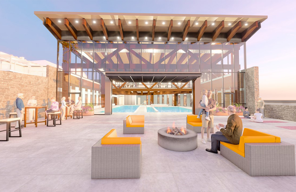 Spacious communal area with seating and fire pit at senior living community.