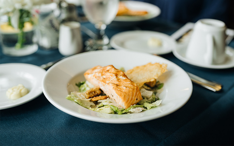 Plate of salmon on an elegantly dressed table