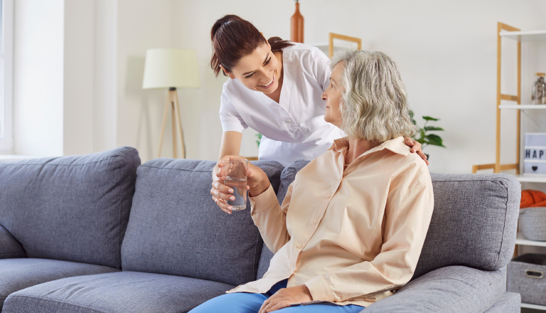 nurse assisting senior woman