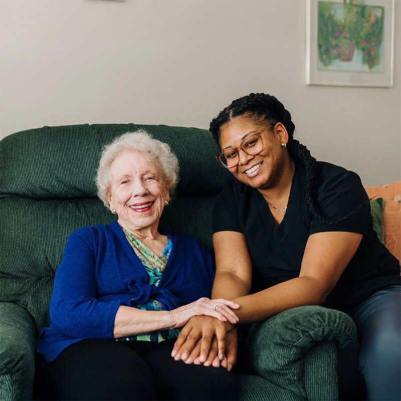 Smiling caregiver with senior woman