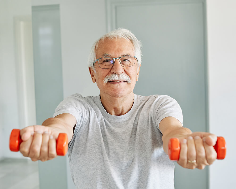 Senior man exercising with hand weights