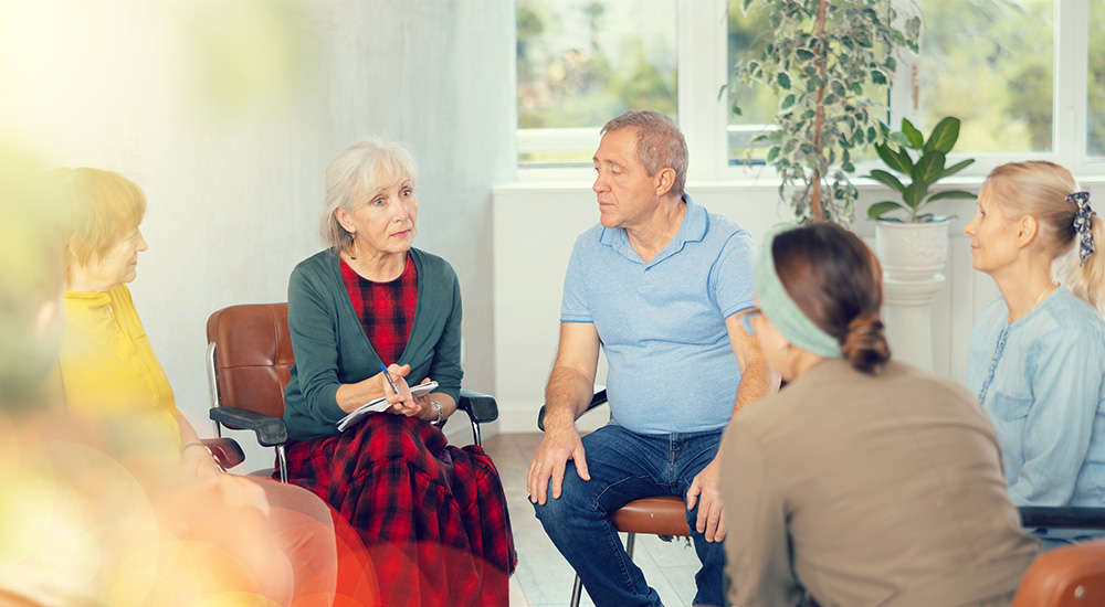 Seniors sitting in a circle have a conversation