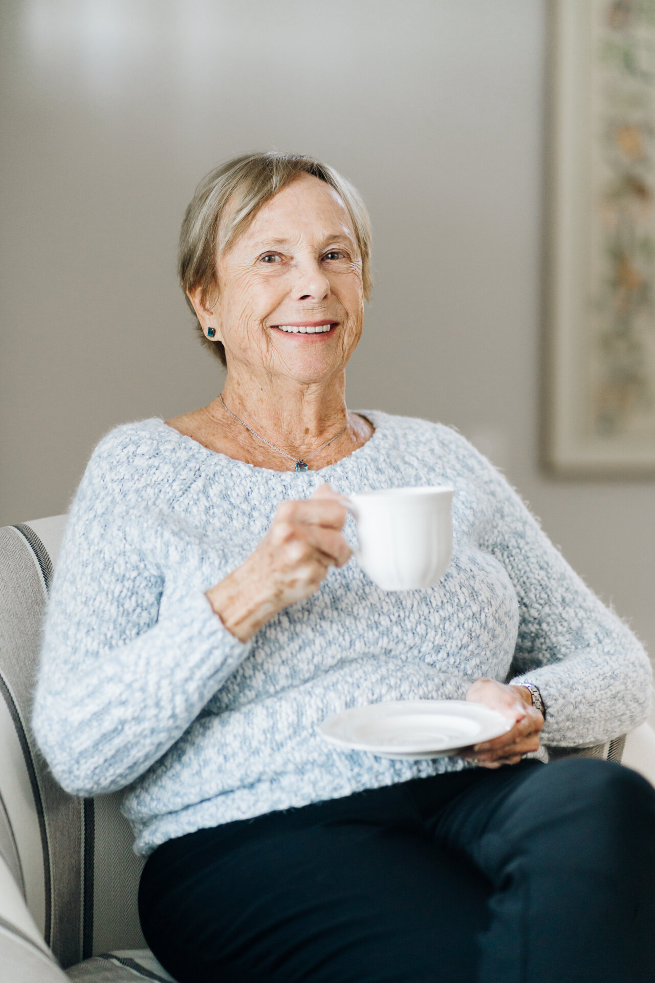 senior woman holding cup of tea