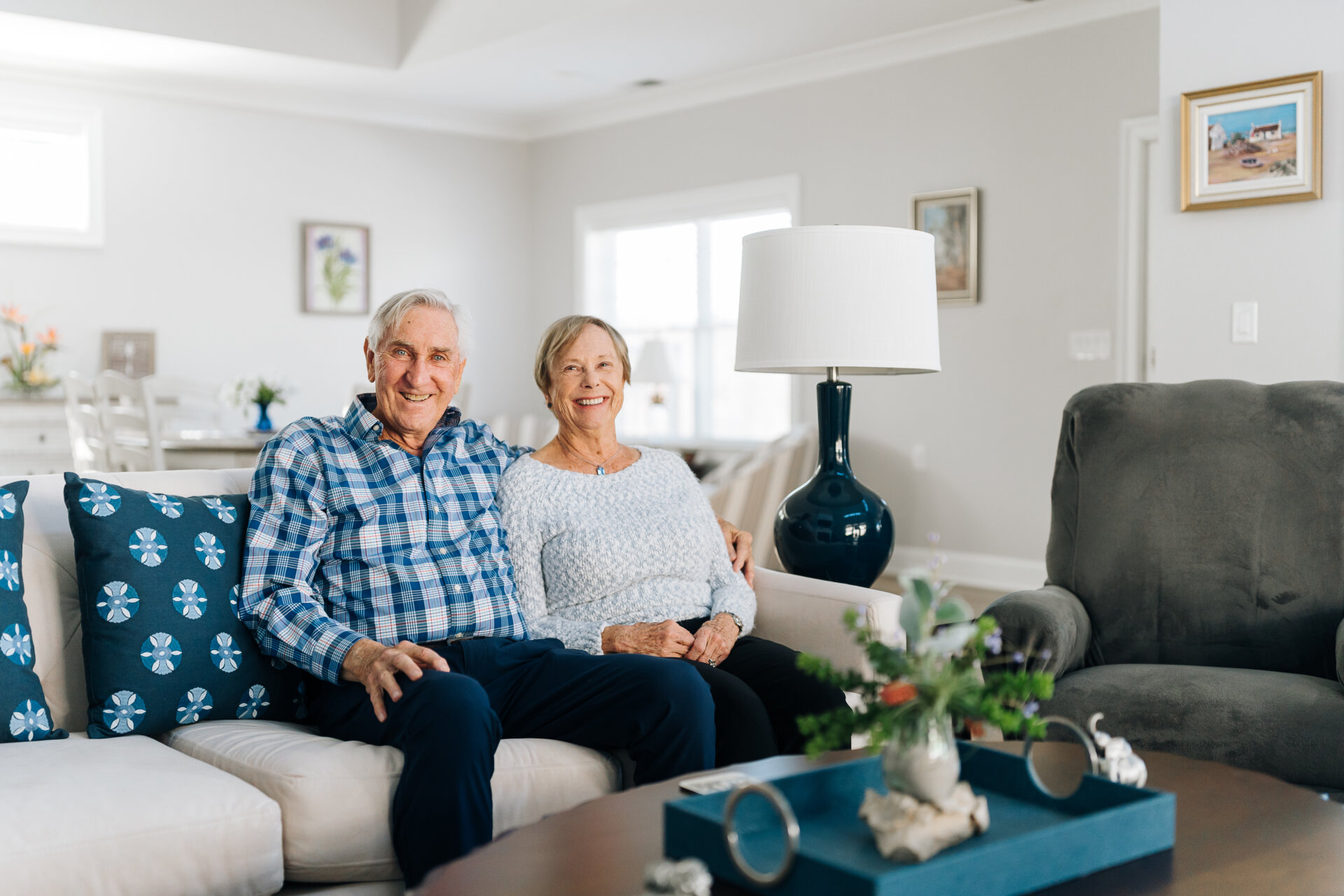Mike and Margie sitting together in their living room in a new cottage